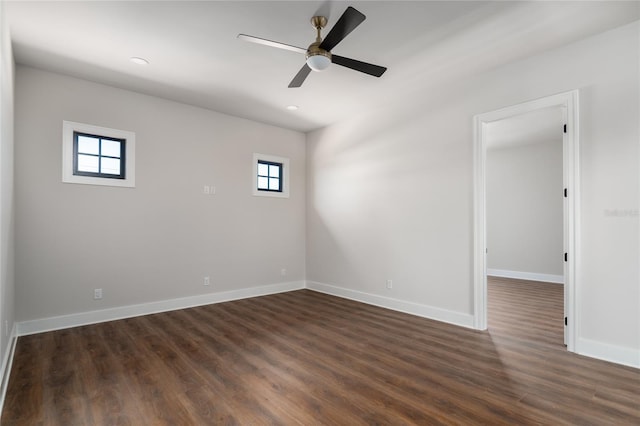 spare room featuring dark wood-type flooring and ceiling fan