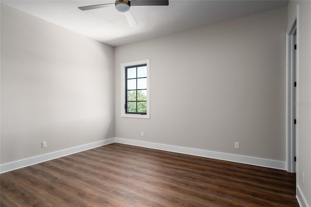 unfurnished room with ceiling fan and dark hardwood / wood-style flooring