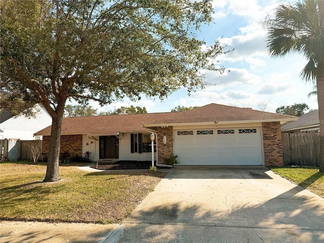 ranch-style home with a garage and a front lawn