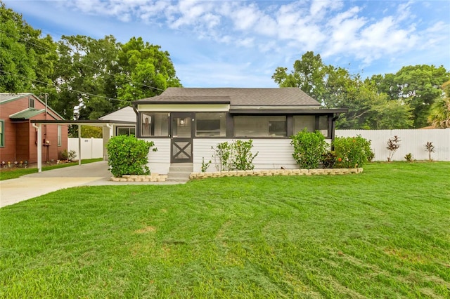 view of front of house featuring a front lawn and a sunroom