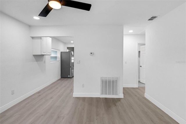 unfurnished living room with ceiling fan and light hardwood / wood-style flooring