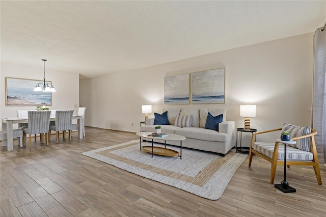 living area with a notable chandelier and wood finished floors