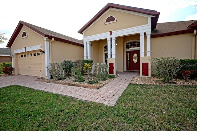 view of front of house featuring a garage and a front lawn