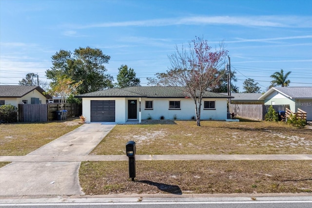 ranch-style home featuring a garage and a front lawn