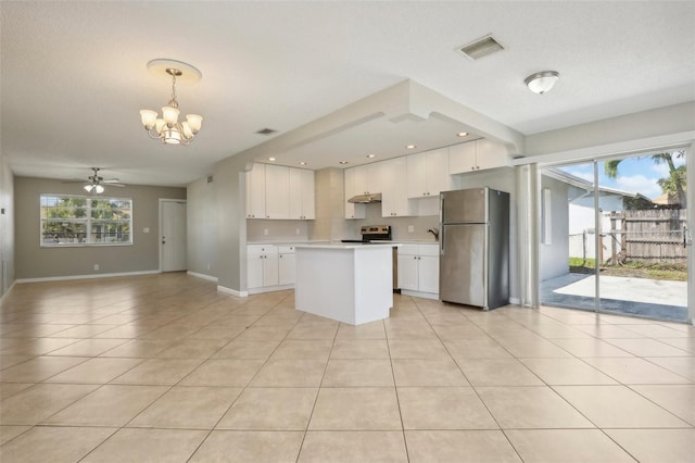 kitchen with pendant lighting, a healthy amount of sunlight, white cabinets, and appliances with stainless steel finishes