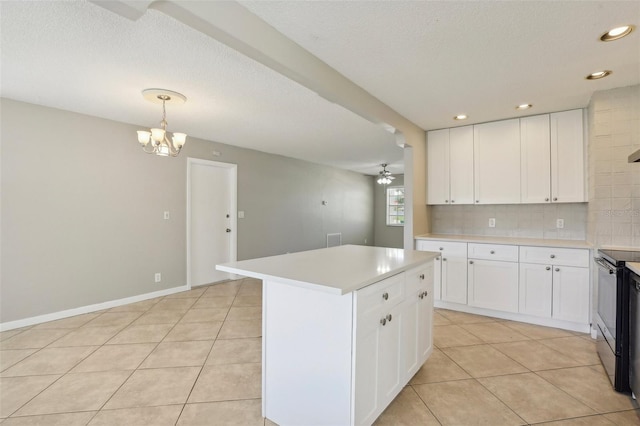 kitchen with light tile patterned floors, stainless steel range with electric stovetop, white cabinets, a kitchen island, and decorative light fixtures