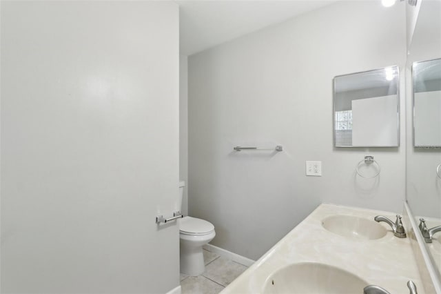 bathroom featuring vanity, tile patterned floors, and toilet