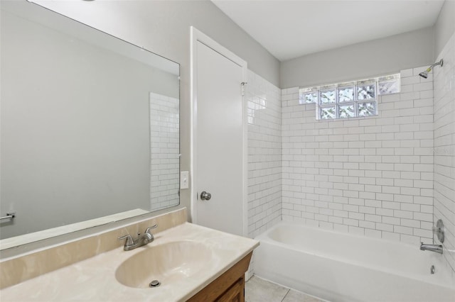 bathroom featuring vanity, tile patterned floors, and tiled shower / bath