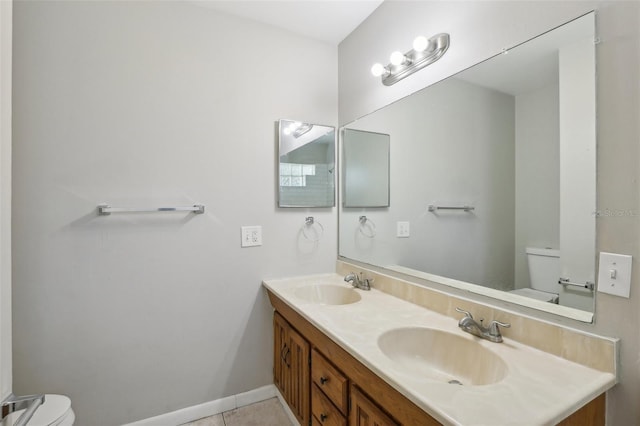 bathroom featuring vanity, tile patterned floors, and toilet