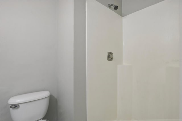 bathroom with a shower and toilet