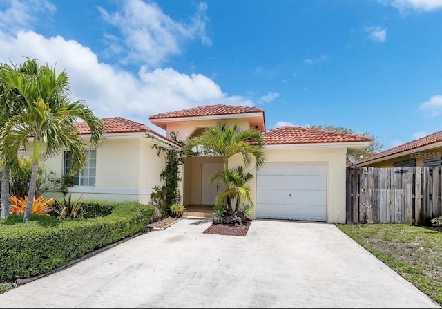 mediterranean / spanish-style home with a garage