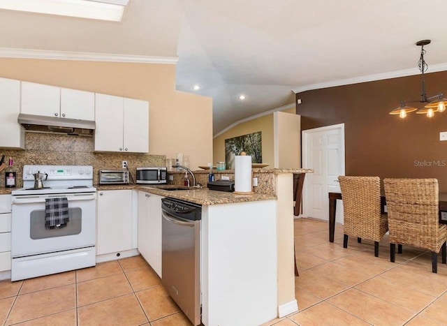 kitchen featuring white cabinetry, appliances with stainless steel finishes, sink, and decorative light fixtures