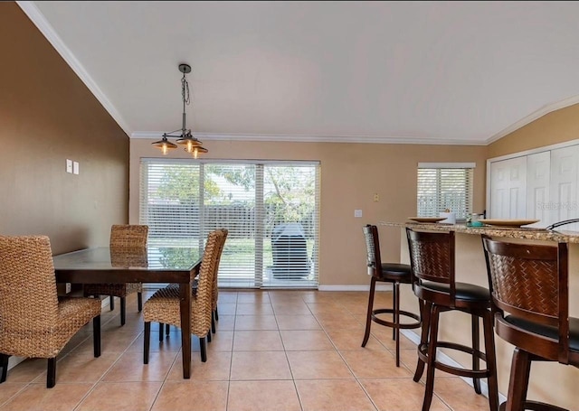 dining room featuring crown molding, lofted ceiling, and light tile patterned floors