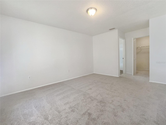 carpeted spare room with a textured ceiling