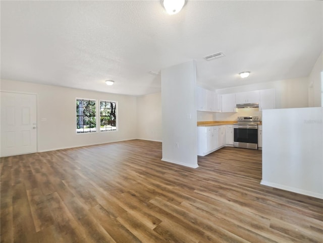 unfurnished living room with hardwood / wood-style flooring and a textured ceiling