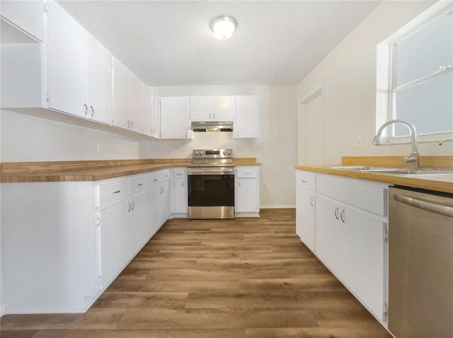 kitchen featuring white cabinetry, sink, light wood-type flooring, and appliances with stainless steel finishes