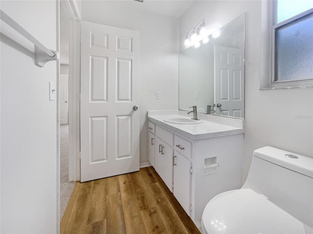 bathroom featuring vanity, hardwood / wood-style floors, and toilet