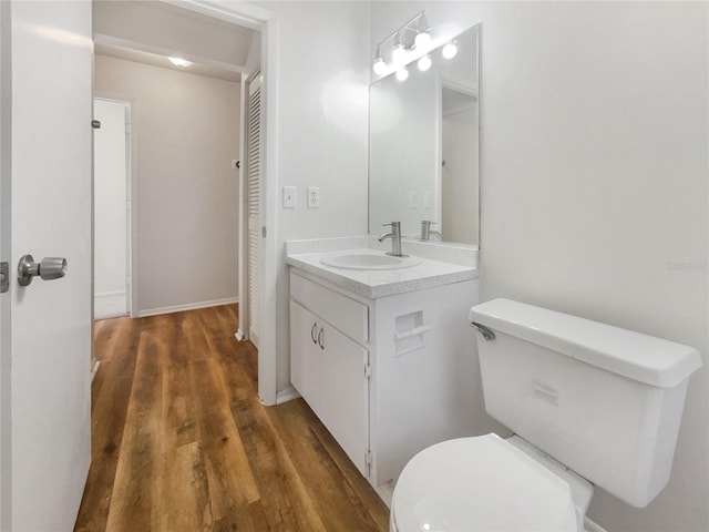 bathroom featuring vanity, hardwood / wood-style flooring, and toilet