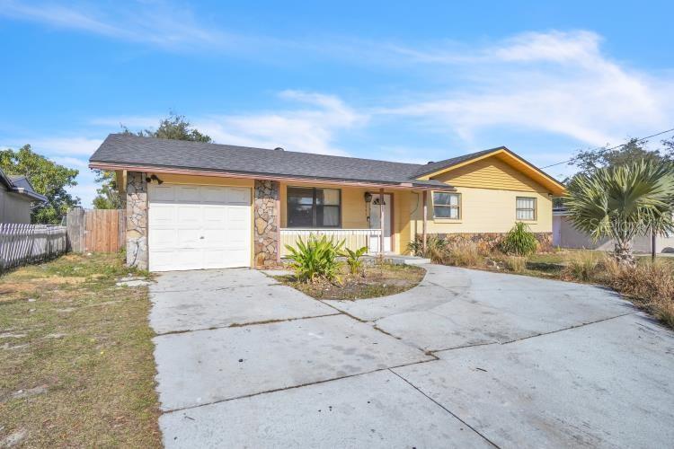 single story home featuring a garage and a porch