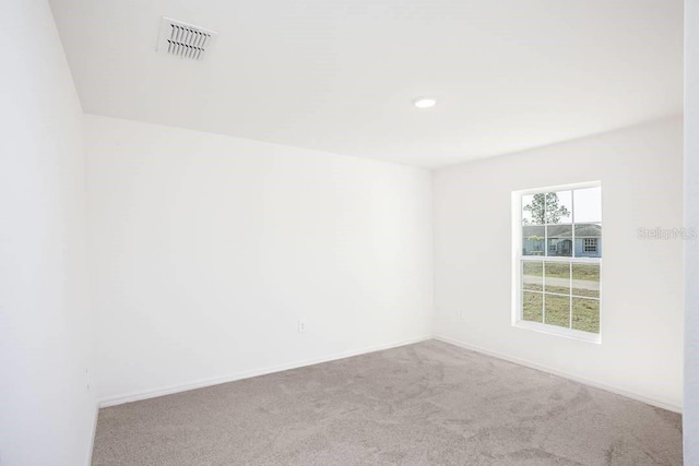 unfurnished room featuring light colored carpet