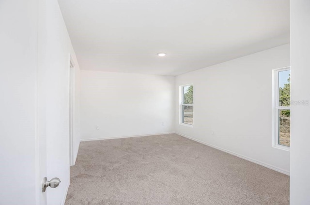 unfurnished room with light carpet