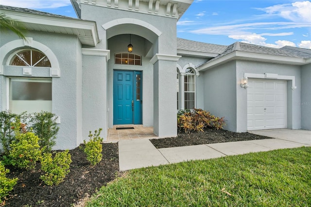 view of exterior entry featuring a garage