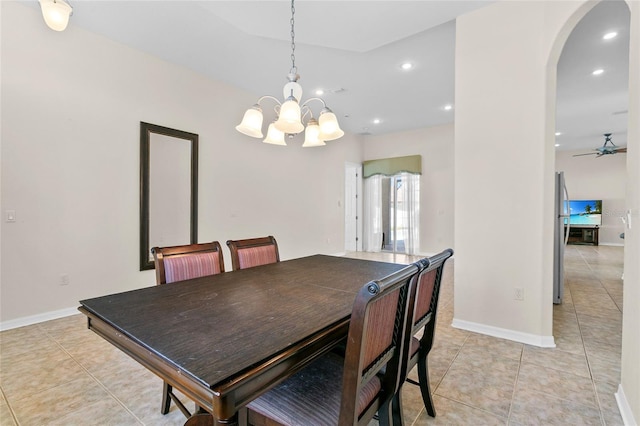 tiled dining area featuring ceiling fan with notable chandelier