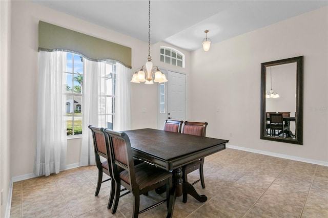 dining area featuring light tile patterned floors and a notable chandelier