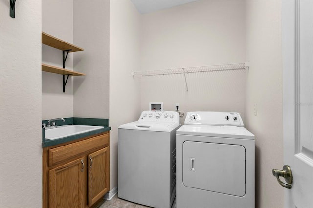 laundry room with sink, cabinets, and washer and dryer