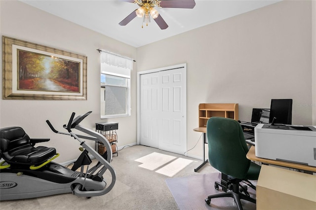 carpeted office space with ceiling fan