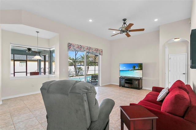 tiled living room with ceiling fan and a wealth of natural light