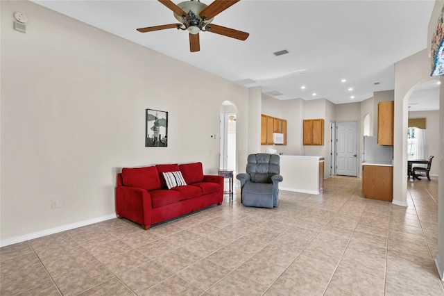 tiled living room featuring ceiling fan