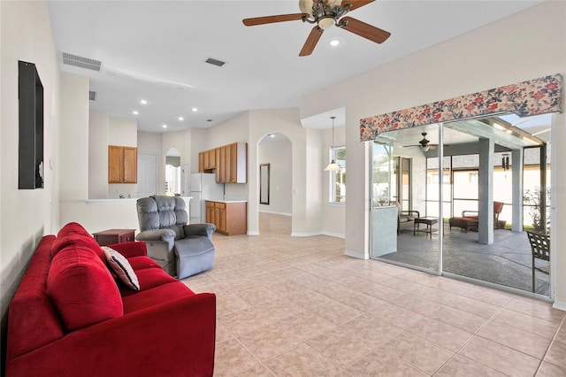 tiled living room with ceiling fan