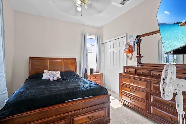 carpeted bedroom with ceiling fan and a closet