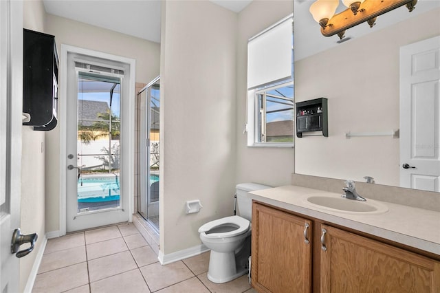 bathroom featuring vanity, toilet, a shower with shower door, and tile patterned flooring