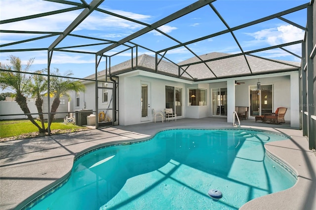 view of swimming pool featuring a lanai, ceiling fan, and a patio area