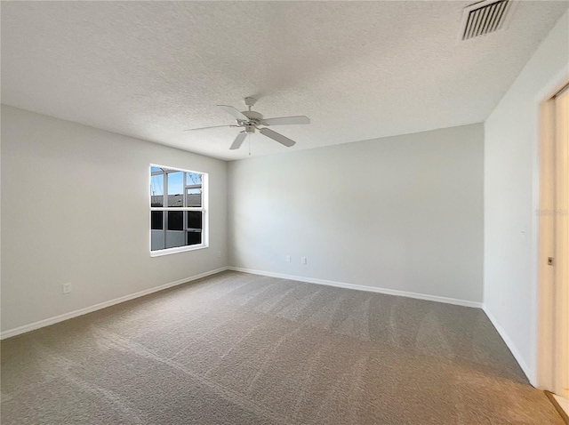 carpeted spare room with ceiling fan and a textured ceiling