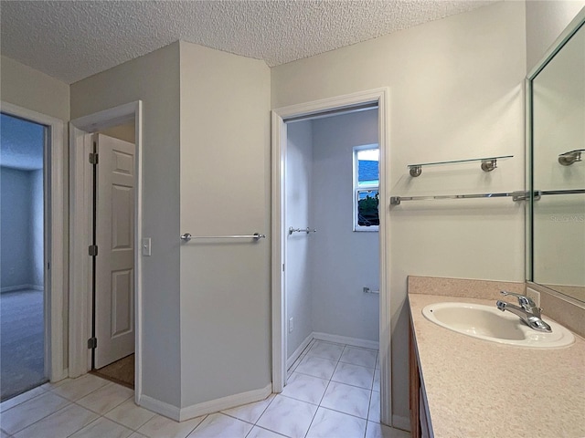 bathroom with vanity, tile patterned floors, and a textured ceiling