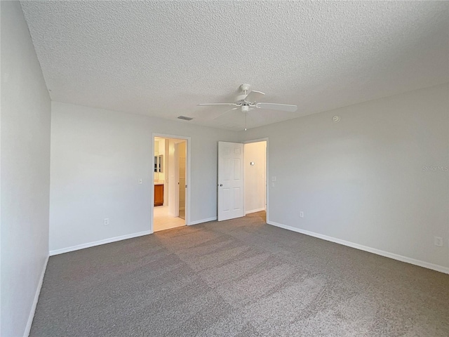 unfurnished bedroom with a textured ceiling, carpet floors, and ceiling fan