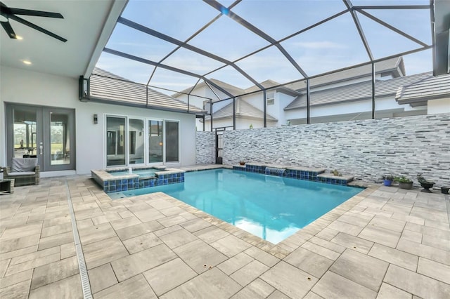 view of swimming pool with an in ground hot tub, ceiling fan, glass enclosure, and a patio area