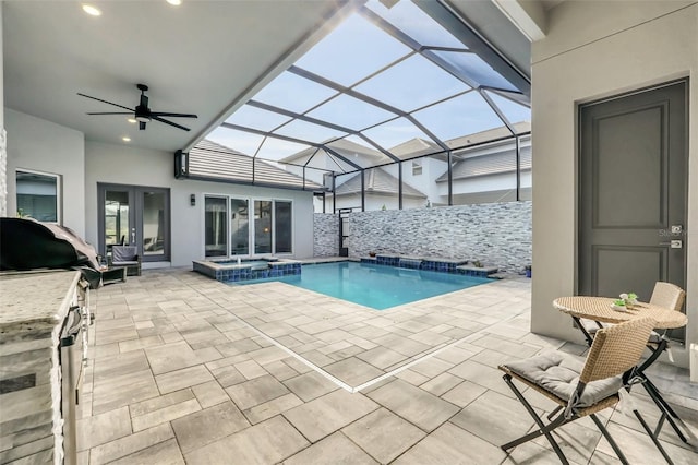 view of pool featuring area for grilling, a lanai, a patio, and an in ground hot tub