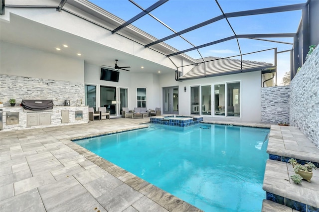 rear view of property featuring a lanai, exterior kitchen, ceiling fan, a patio area, and an in ground hot tub