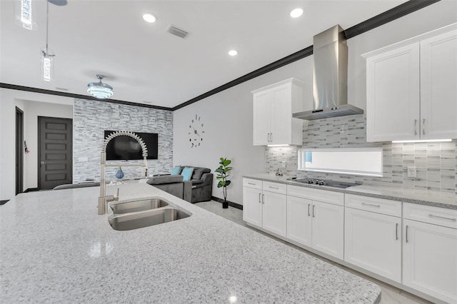 kitchen featuring white cabinetry, ornamental molding, black electric stovetop, light stone counters, and wall chimney exhaust hood