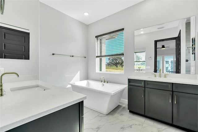 bathroom with a tub to relax in and vanity