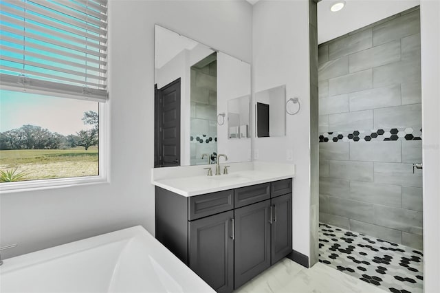 bathroom featuring vanity and tiled shower