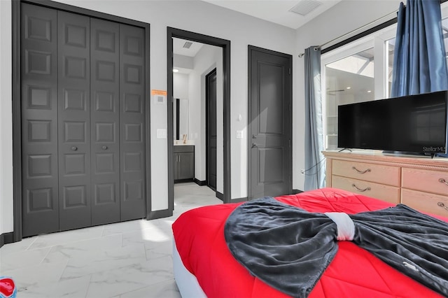 bedroom with a closet and ensuite bathroom