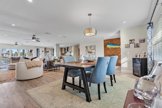 dining area with beverage cooler and light hardwood / wood-style floors