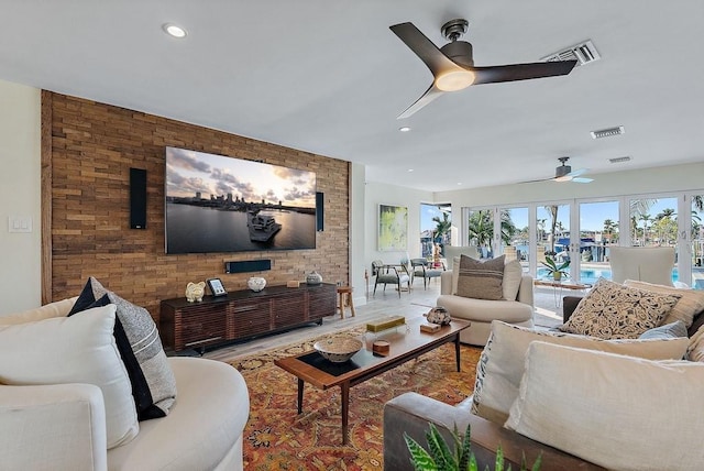 living room featuring ceiling fan and light wood-type flooring