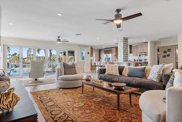 living room featuring hardwood / wood-style flooring and ceiling fan