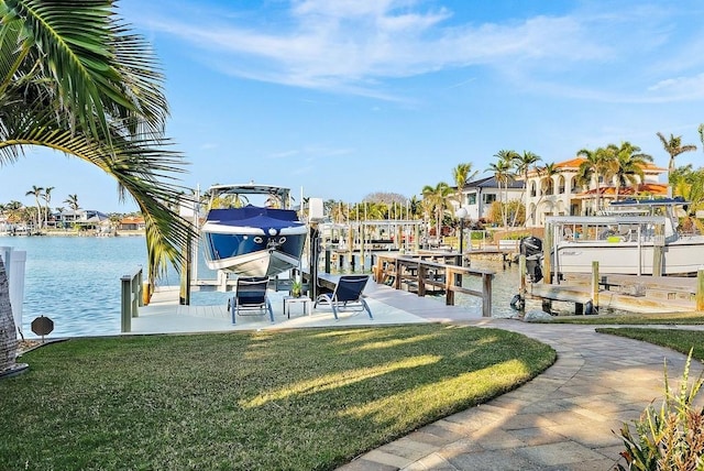 view of dock with a water view and a yard